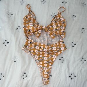 Yellow one piece swim suit with white and pink flowers